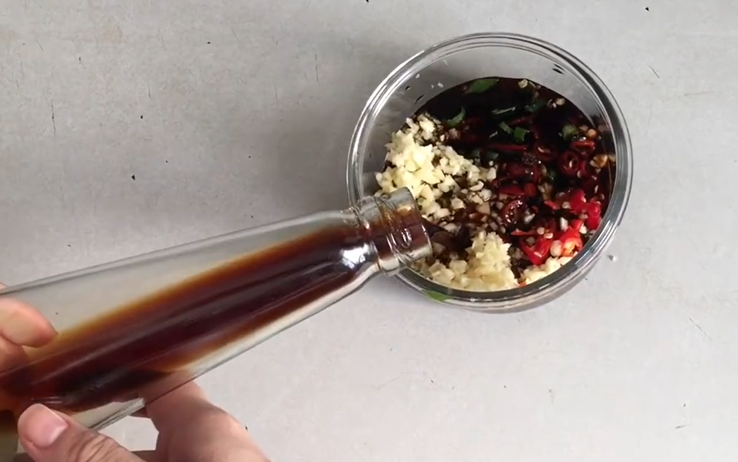 5.將黑豆醬油倒入蔥花、蒜仁、辣椒的容器中，淹過配料，攪拌均勻